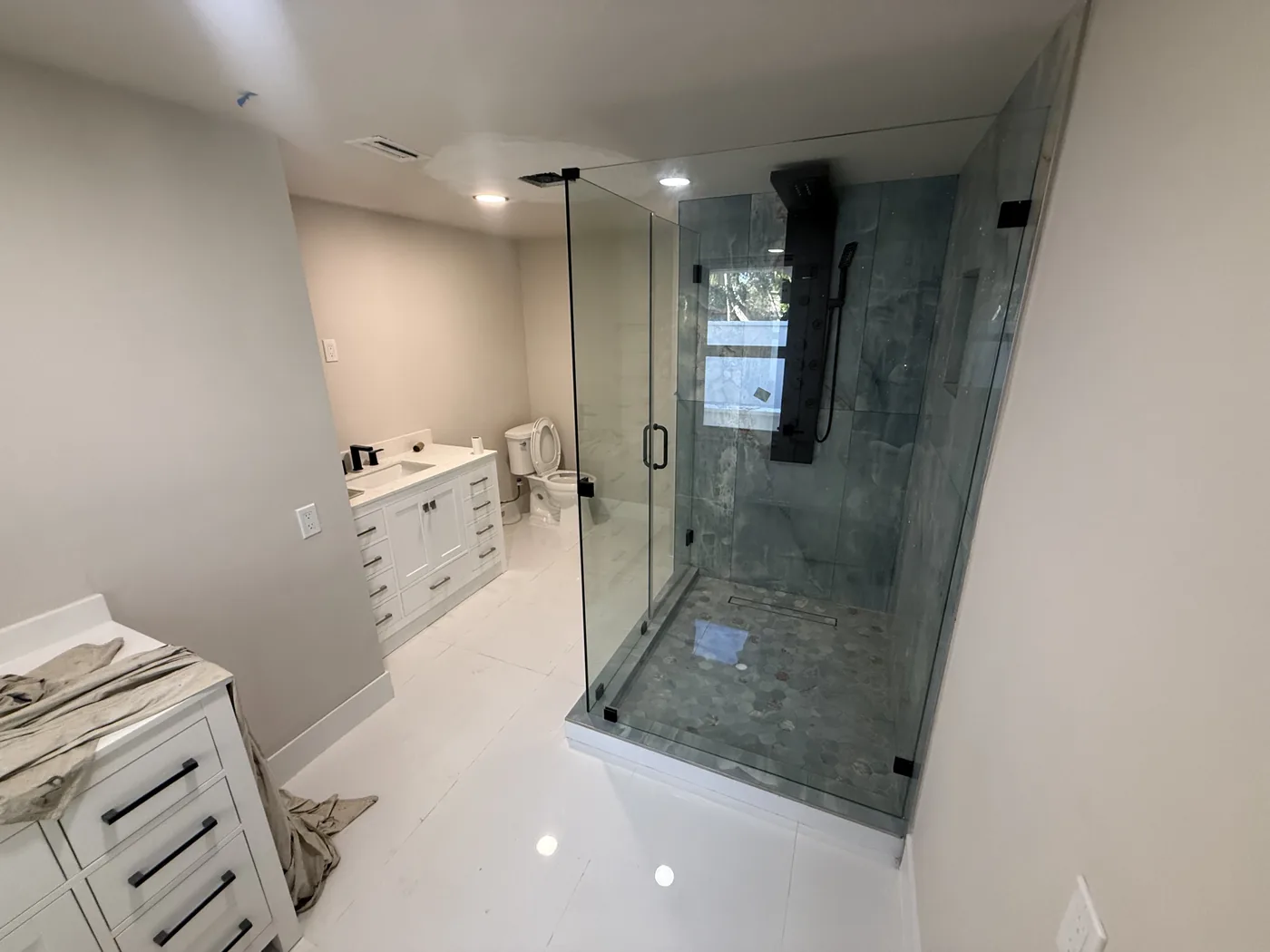 Frameless glass shower in a finished bathroom remodel