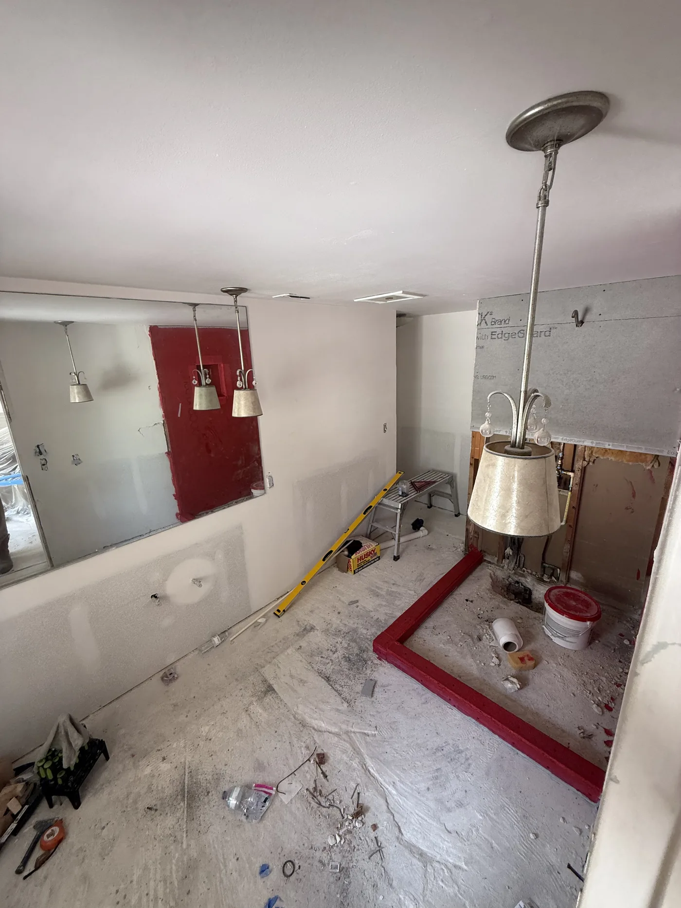 Bathroom mid-remodel with waterproofing in place before tiling