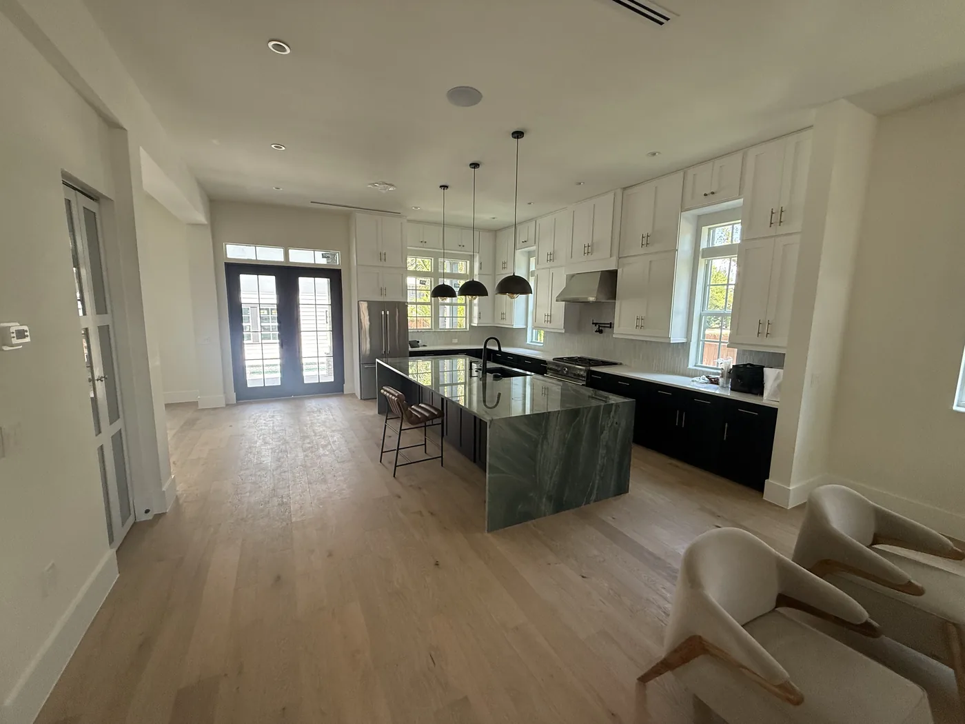 Open plan kitchen with an island and wood flooring throughout
