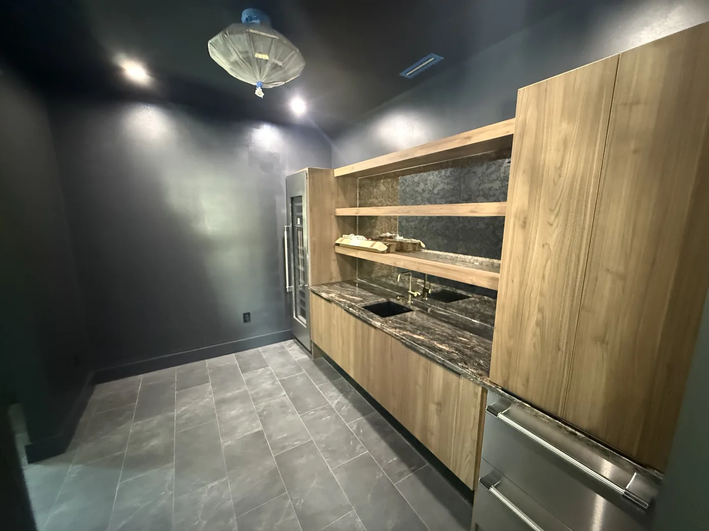 Bar area with custom cabinetry and a stone countertop