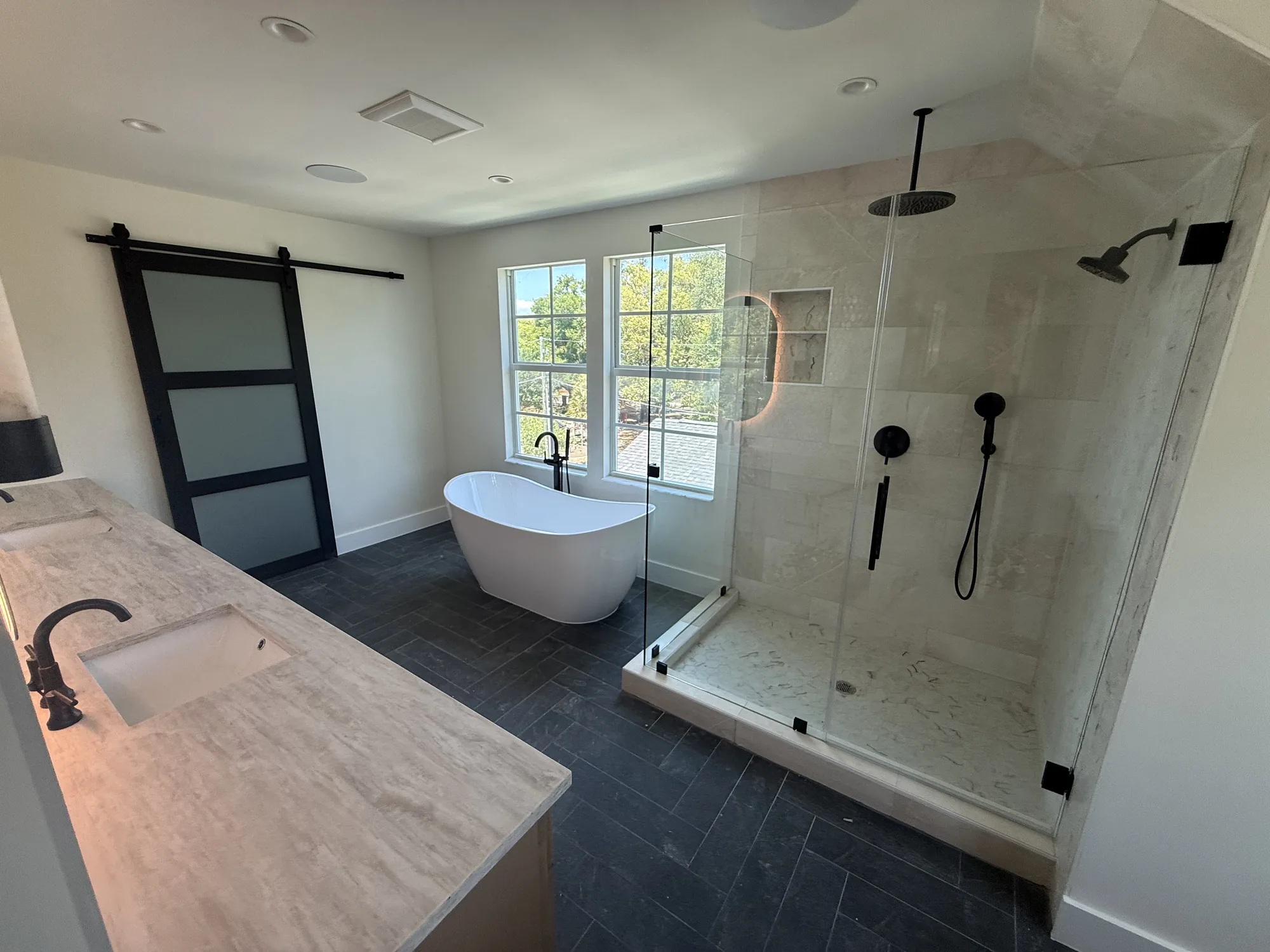 Completed master bathroom with a freestanding tub and walk-in shower